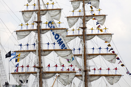 Port of Amsterdam, Noord-Holland, Netherlands - August 19, 2015: Sailors on the masts of the tall ship Arc Gloria from Colombia constantly sail in 2015のeditorial素材