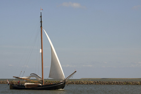 Enkhuizen, the Netherlands - June 7, 2015: Old wooden sailing boat sailing on a sunny dayのeditorial素材