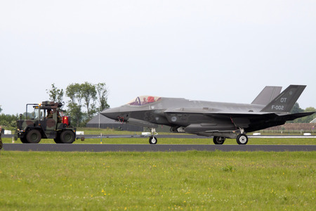 LEEUWARDEN, THE NETHERLANDS - JUNE 11 2016: joint Straight F 35 fighter was towed to the hangar after a demonstration flight. this replaces the F16 at the Dutch Air Forceのeditorial素材