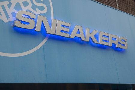 HORN, THE NETHERLANDS - SEPTEMBER 17, 2016: 85 / 5000Blue and white logo with large letters or sneakers on a sneaker shop for shoes on September 17.2016 in Hoornのeditorial素材