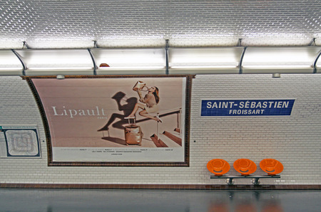 PARIS, FRANCE - JULY 23, 2017: Paris metro station with orange benches and old white tiles on the wallのeditorial素材
