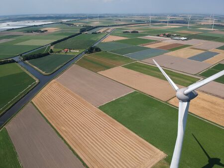 Drone photo of a large windmill with a total height of 198 meters with a shaft height of 135 meters. In the background, the wieringermeer polder. Photo tasks at an altitude of 204 metersの写真素材
