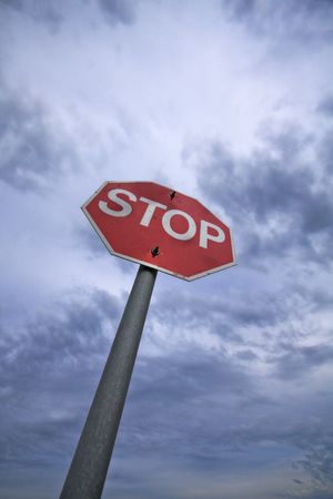 Stop sign with a cloudy sky backgroundの写真素材