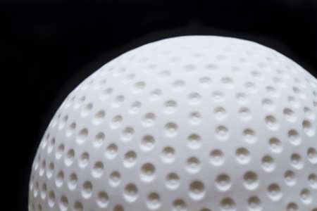 Detailed golf ball fondant icing cake close-up with a dark backgroundの写真素材
