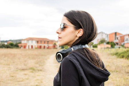 Women closeup outdoors with headphones and sunglassesの写真素材