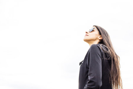 Women closeup outdoors with headphones and sunglassesの写真素材
