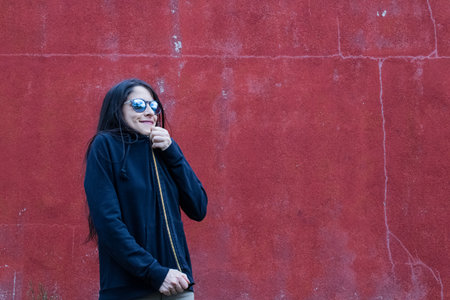 Women closeup outdoors with headphones and sunglassesの写真素材