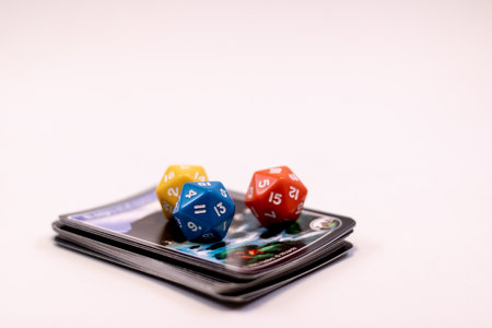 yellow, blue, red role play game dice over cardsの写真素材
