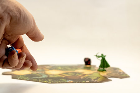 A hand throwing rpg dice on an adventure tileの写真素材