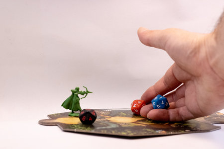 A hand throwing rpg dice on an adventure tileの写真素材