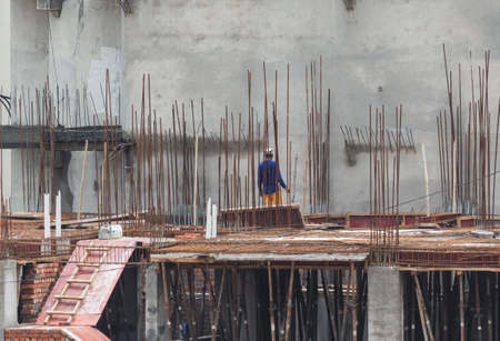 A construction worker working on the roof supported by barsの写真素材