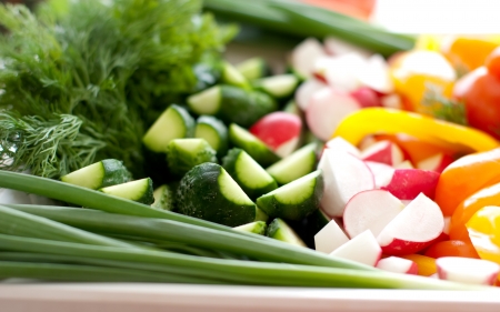 Multi-colored fresh vegetables, cut, on a plateの写真素材