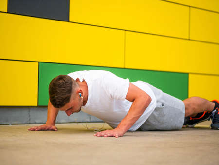 A shallow focus shot of a Caucasian male doing workout in a park