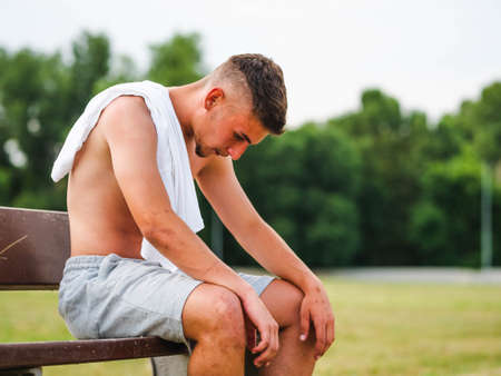 A young attractive sportsman relaxing after training - workout conceptの写真素材