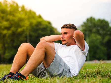 A shallow focus shot of a Caucasian male doing workout in a parkの写真素材