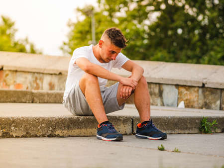 A young attractive sportsman relaxing after training - workout conceptの写真素材