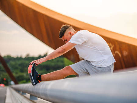 A young attractive sportsman having training outdoors - workout conceptの写真素材