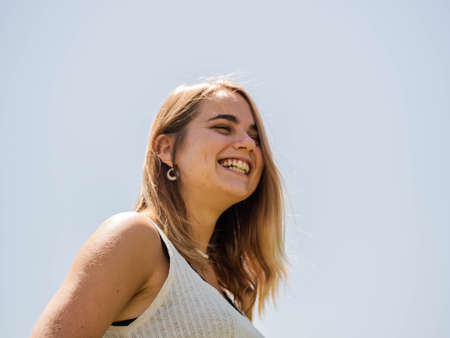 A young Caucasian blonde woman happily smilingの写真素材