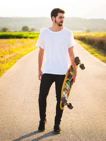 A young Caucasian couple learning to skate in the street, A shallow focus shot of a beautiful lovely...