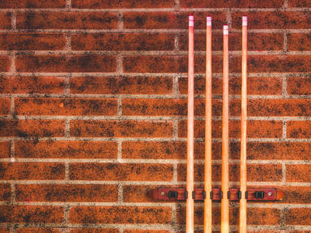 set of billiard sticks on a brick wallの写真素材