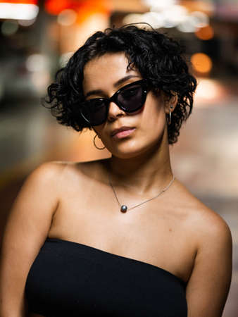 Stylish young female with sunglasses. Stylish female model with vibrant makeupの写真素材