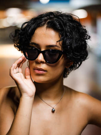 Stylish young female with sunglasses. Stylish female model with vibrant makeupの写真素材