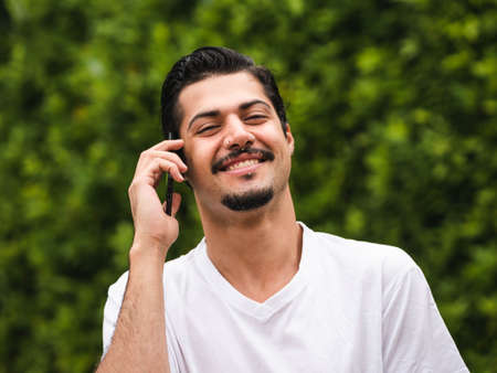 Man looking at his cellphone smartphone making selfie