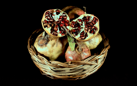 basket with pomegranate fruit open in twoの写真素材