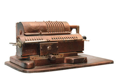 Old cast metallic calculating machine on whiteの写真素材