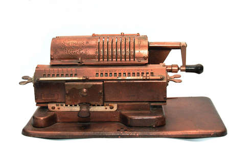 Old cast metallic calculating machine on whiteの写真素材