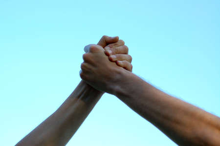 Two hands keeping together up in the skyの写真素材
