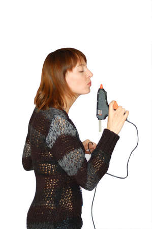 Woman is holding silicone bonding pistol in her handの写真素材