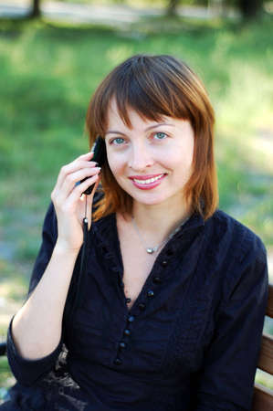 Young pretty woman making a call by cellphoneの写真素材
