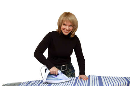 Smiling pretty woman during ironing on whiteの写真素材