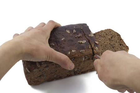 Cutting Brown (rye) bread on white backroundの写真素材