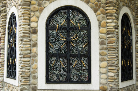 View to facade of the restaraunt building with three windows and walls with stonesの写真素材