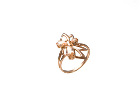 Big golden ring with beige gems isolated on the white backgroundの写真素材