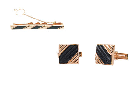 Masculine accessories - set of golden cufflinks  and clamp for a tie isolated on white backgroundの写真素材