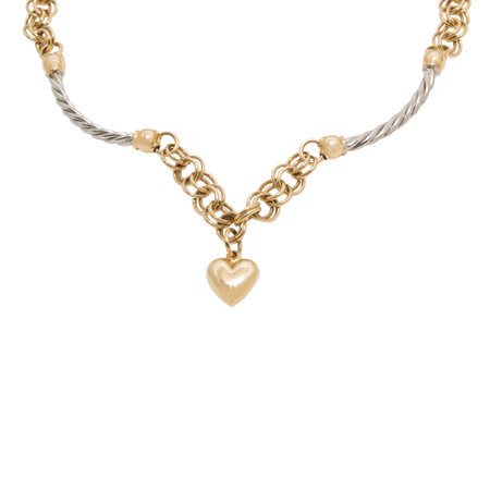 The part of fashionable golden necklace from yellow and white gold with heart shape pendant isolated on white backgroundの写真素材