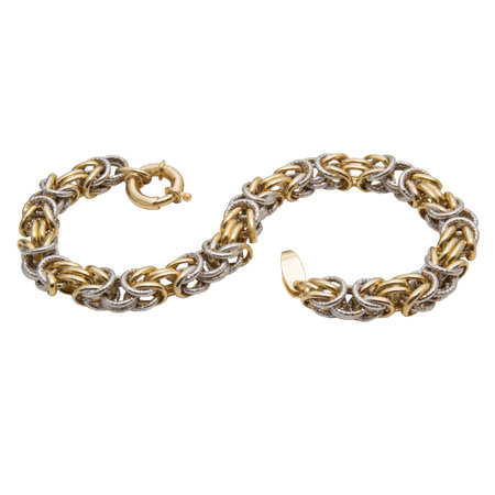 Graceful golden chain shape bracelet from yellow and white gold isolated on white backgroundの写真素材