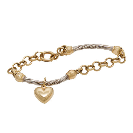 Fashionable golden bracelet with heart shape pendant from yellow and white gold isolated on white backgroundの写真素材