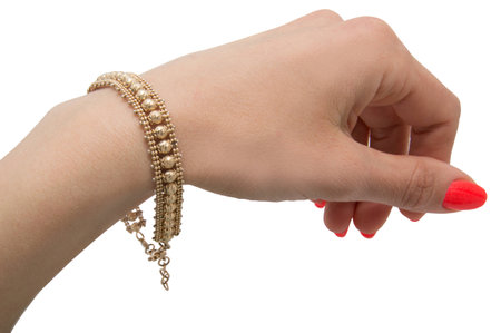 Unusual graceful golden bracelet with baloons on woman wrist isolated on white backgroundの写真素材