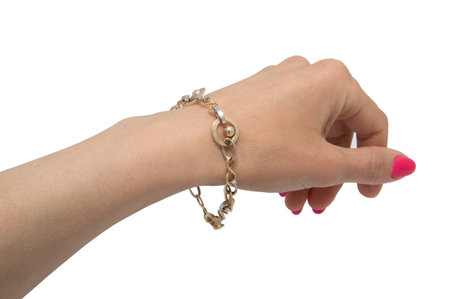Graceful golden bracelet on woman hand isolated on white background made from white and yellow goldの写真素材