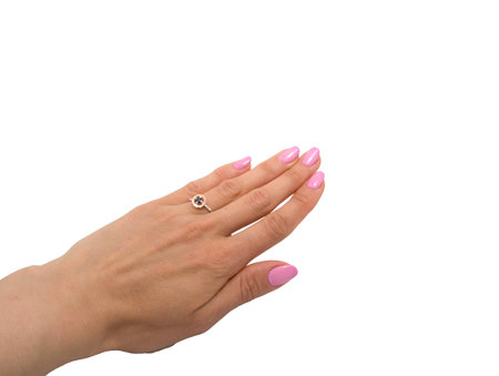 Golden ring with dark blue gem - sapphire and few diamonds on woman's hand isolated on white backgroundの写真素材