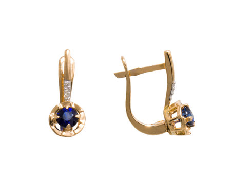 Golden earrings with dark blue gem - sapphire and few diamonds isolated on white backgroundの写真素材