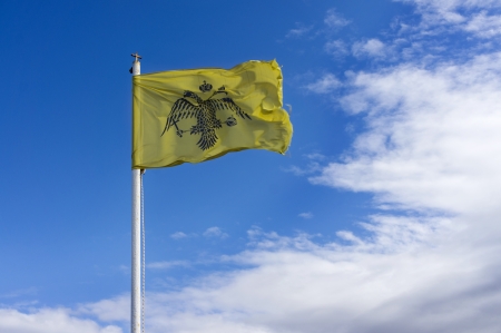 Byzantine flag under blue sky isolatedの写真素材