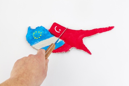 The dichotomy of Cyprus into three parts Turkey, Russia, European Union with a knife (Concept Cyprus financial crisis)の写真素材