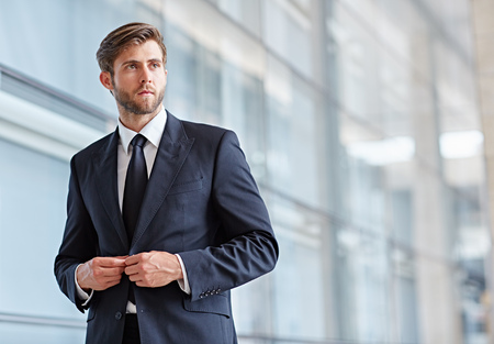 Portrait of a stylish corporate executive looking seriously away into the distanceの写真素材