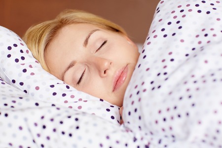 Closeup of a young woman sleeping in her bed