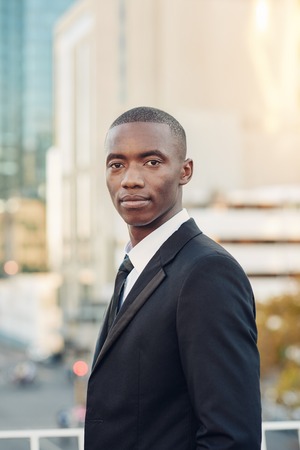 Portrait of a young African man wearing a smart suit and looking like he could be a finance...